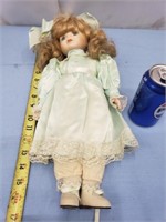 Porcelain doll with lime green dress needs stand