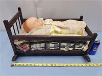 Plastic doll in cradle with minimal stains