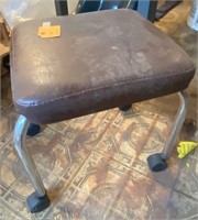 Mobile brown seat on wheels stool