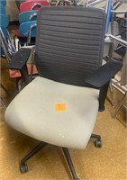 Grey office chair with black adjustable arms