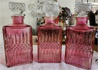 Trio of Pink Glass Decanters w/ Stoppers