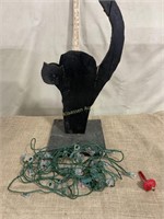 Black wooden cat with string of lights