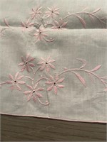 Two pink and white embroidered table runners