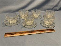 Six. Cut glass cups and saucers.