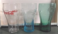 Assorted vintage Coca-Cola glasses. No visible