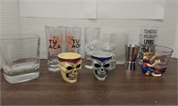Assorted shot glasses and Jack Daniel's whiskey