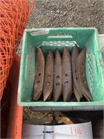 Green crate of cultivator teeth