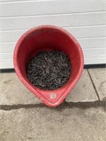 Red pail of fence staples
