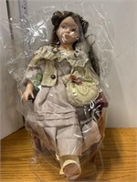 Doll in chair