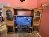 Large wood and glass entertainment center.