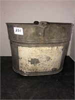 Metal bucket with paint brushes