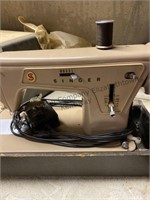 Singer sewing machine and a button holer