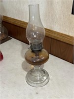 Older glass kerosene oil lamp with oil in it.