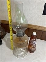Vintage glass kerosene lamp with bottle of oil.