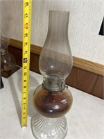 Vintage glass kerosene lamp with some oil in it.
