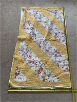 Homemade quilt showing some signs of wear