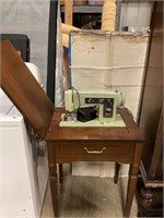 Antique sewing machine with cabinet