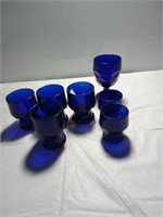 Seven cobalt blue drinking glasses