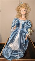 Curly Blond Haired China Doll in Blue Satin Gown