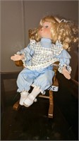 Blonde Hair Blue Eyed China Doll in rocking chair