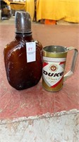 One brown glass water container, Duke beer tin