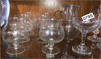 Glass champagne glasses and small pitcher