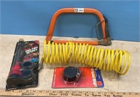 Small bucksaw, air hose, gas can spout and a 6ft