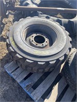 LIKE NEW SKID STEER TIRE ON OFFSET RIM