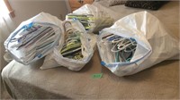 Four bags of plastic hangers