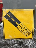 Metal road sign: pavement to gravel