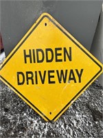 Metal road sign: hidden driveway
