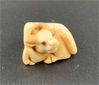 Antique mammoth netsuke of a small bull or ox curl