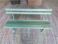 Green wood and cast iron bench