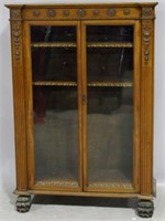 Carved English bookcase on hairy paw feet