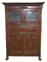 Monumental carved multi compartment armoire