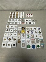 Large assortment of tokens, pins, and