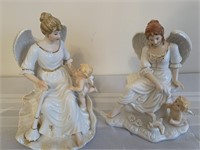Pair of porcelain angel figurines with cherubs