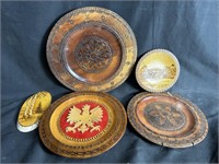 Four Polish wood plates, some brass-inlaid,