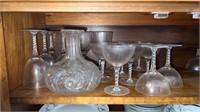 Shelf of wine glasses and decanter missing lid