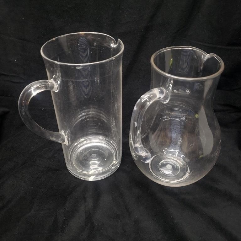 Two clear plastic jugs pitchers