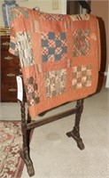Antique quilt stand and hand sewn quilt