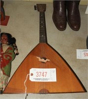 Three string triangular instrument 16” x 28”