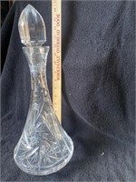 Tall, crystal decanter.