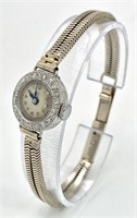 A ladies, platinum watch with diamond bezel and a