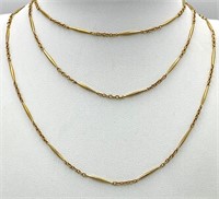 An unusual, 9 K yellow gold and very long (100 cm)