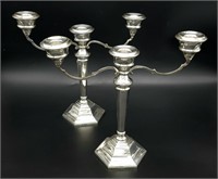 A PAIR OF SILVER CANDELABRA EACH HOLDING 3 CANDLES