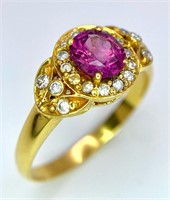 An 18K Yellow Gold Pink Sapphire and Diamond Ring.