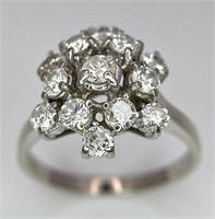 An 18 K white gold ring with a cluster of diamonds
