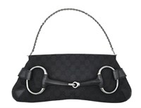 A Gucci GG black canvas bag featuring the black an