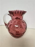 Cranberry glass pitcher, ruffled top